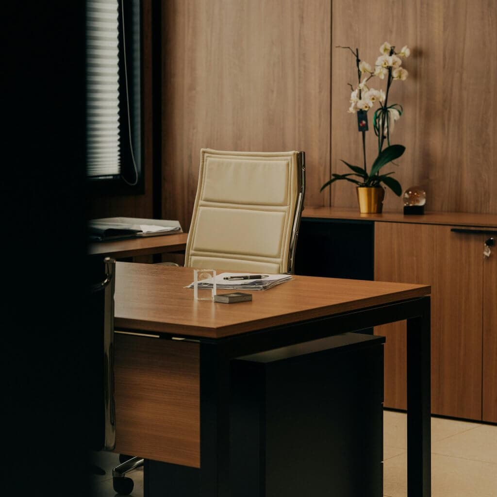 A quiet, wood-paneled law office with a leather desk chair